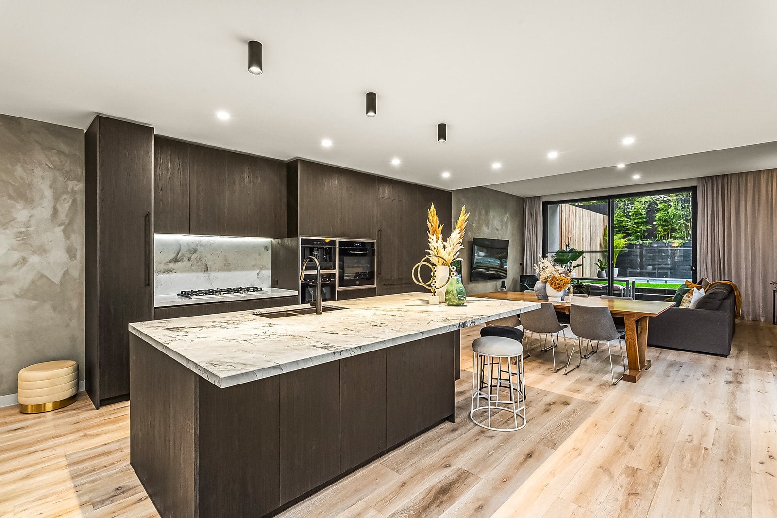 Kitchen with a marble island and dark timber joinery, Aberfeldie
