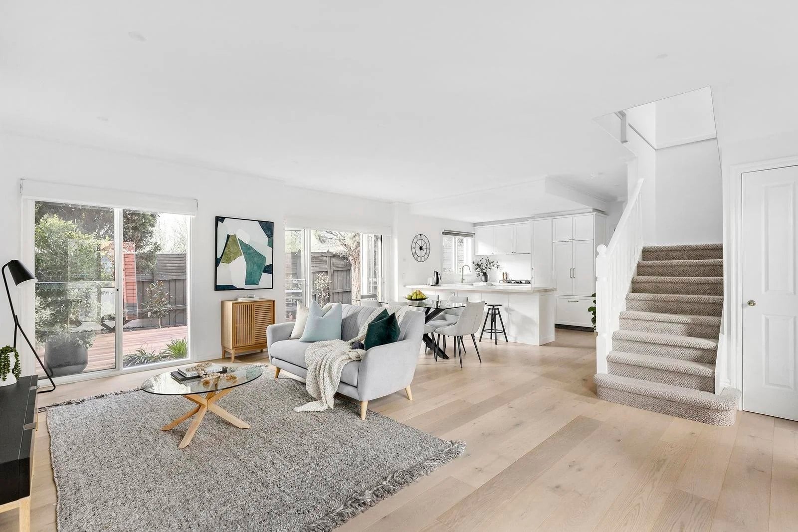 Living room with a carpeted stair and the kitchen beyond, pale timber floors, Ivanhoe